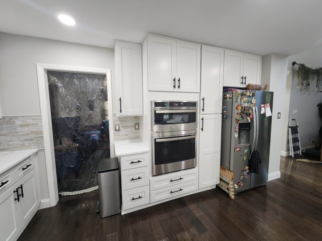 White kitchen cabinets with wall ovens
